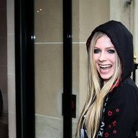 Avril Lavigne is all smiles as she leaves her Paris hotel photos
